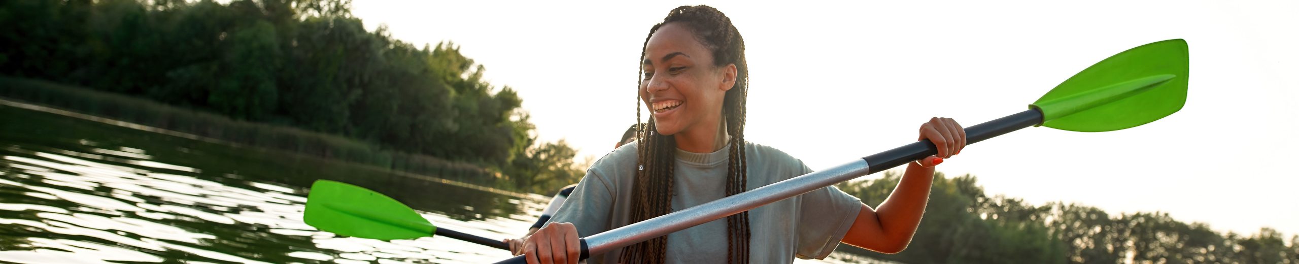 Woman smiling at water while kayaking